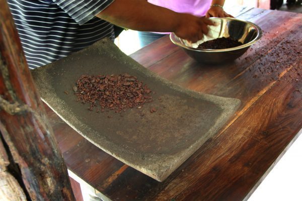 Beans in the Matate, A Volcanic Basalt Rock Maya Chocolate Making Process in Belize