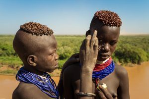 Karo boys painting themselves