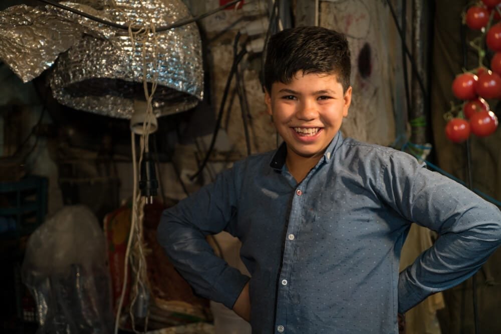 Kid selling produce at the Bazaar in Shiraz, Iran