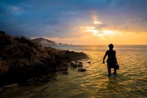 Abdullah walking on the beach in the sunset. Socotra
