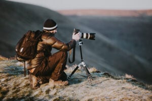 12 Best Camera Backpacks for Travel: Ultimate Guide 8 Photographer with backpack in the outdoors