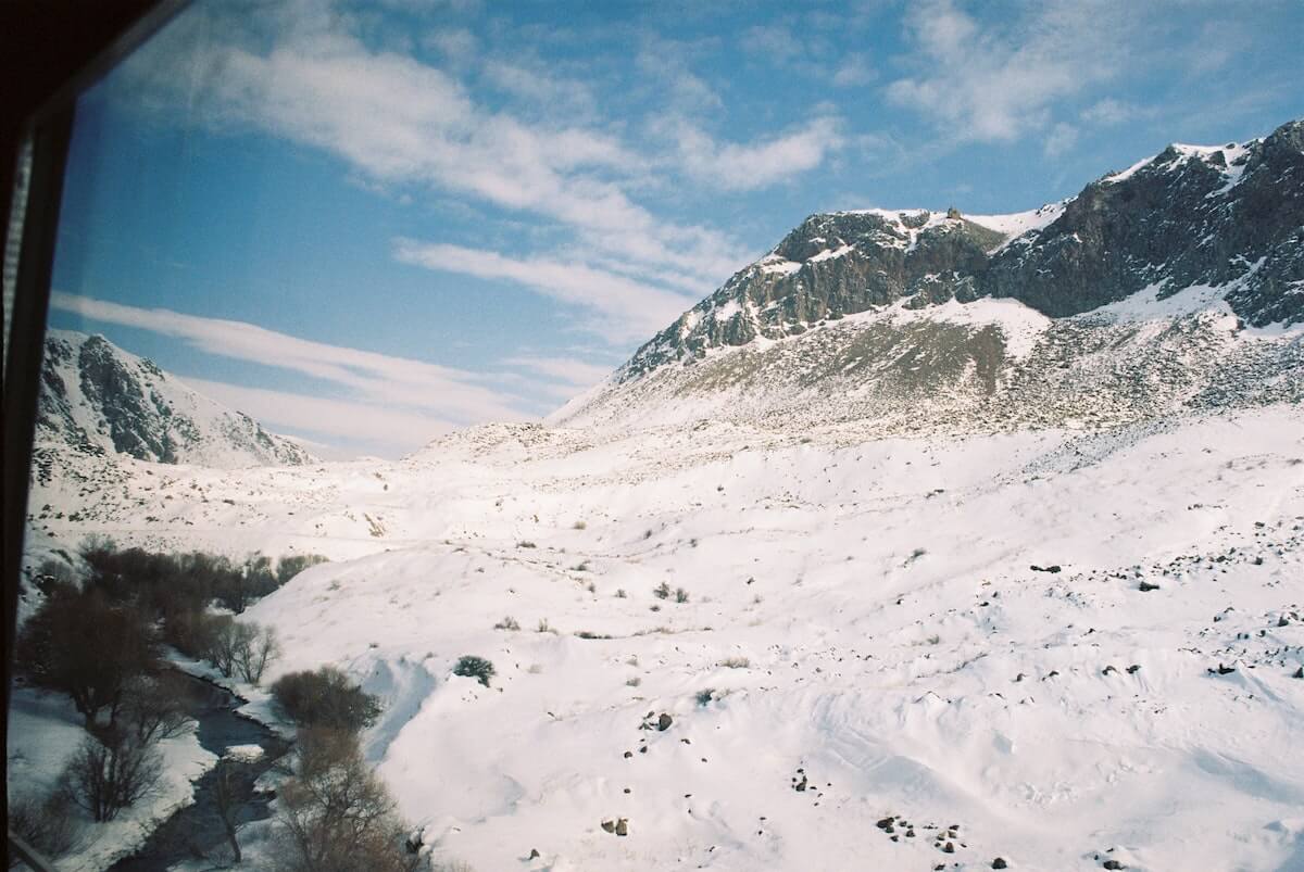 Snowy mountains through train window in Switzerland
