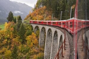 Train in Switzerland crossing a bridge with Fall Foliage