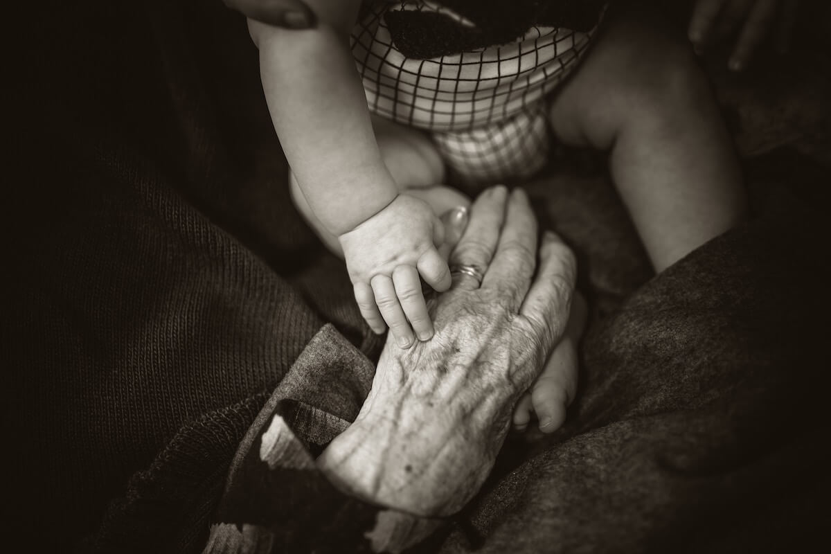 Elderly Hand with a Baby