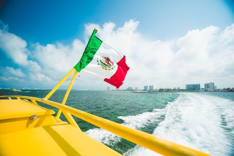 Is Cancun Safe? | Safety Tips & What to Know Before You Go 9 Mexican Flag on a boat in in Cancun